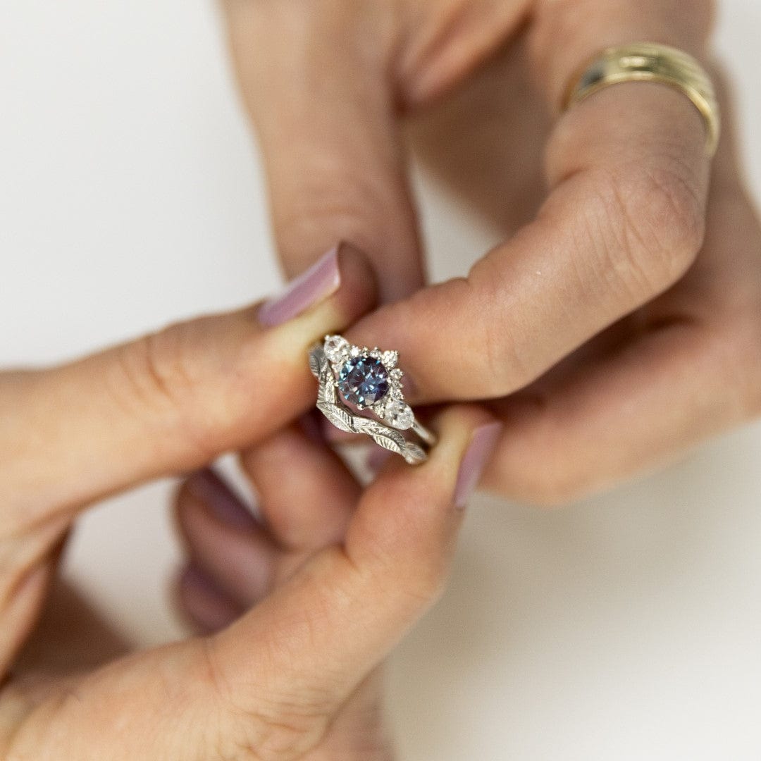 alexandrite and lab diamond cluster engagement ring with leaf wedding band white gold
