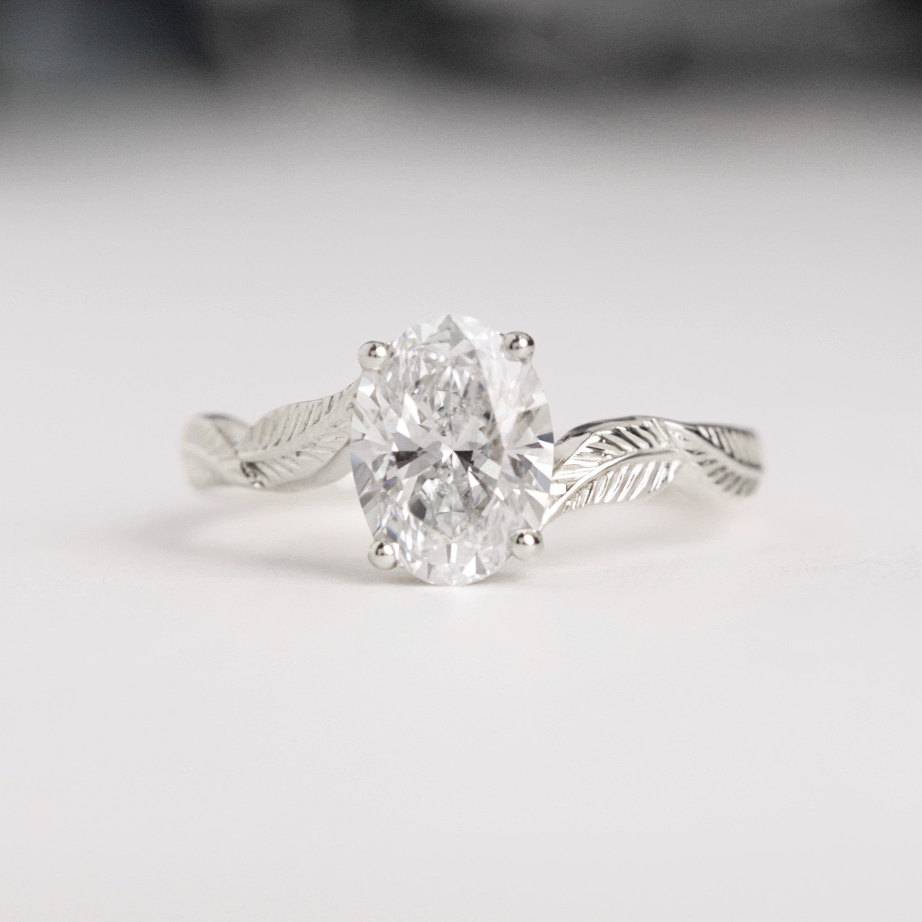 oval diamond leaf engagement ring white gold