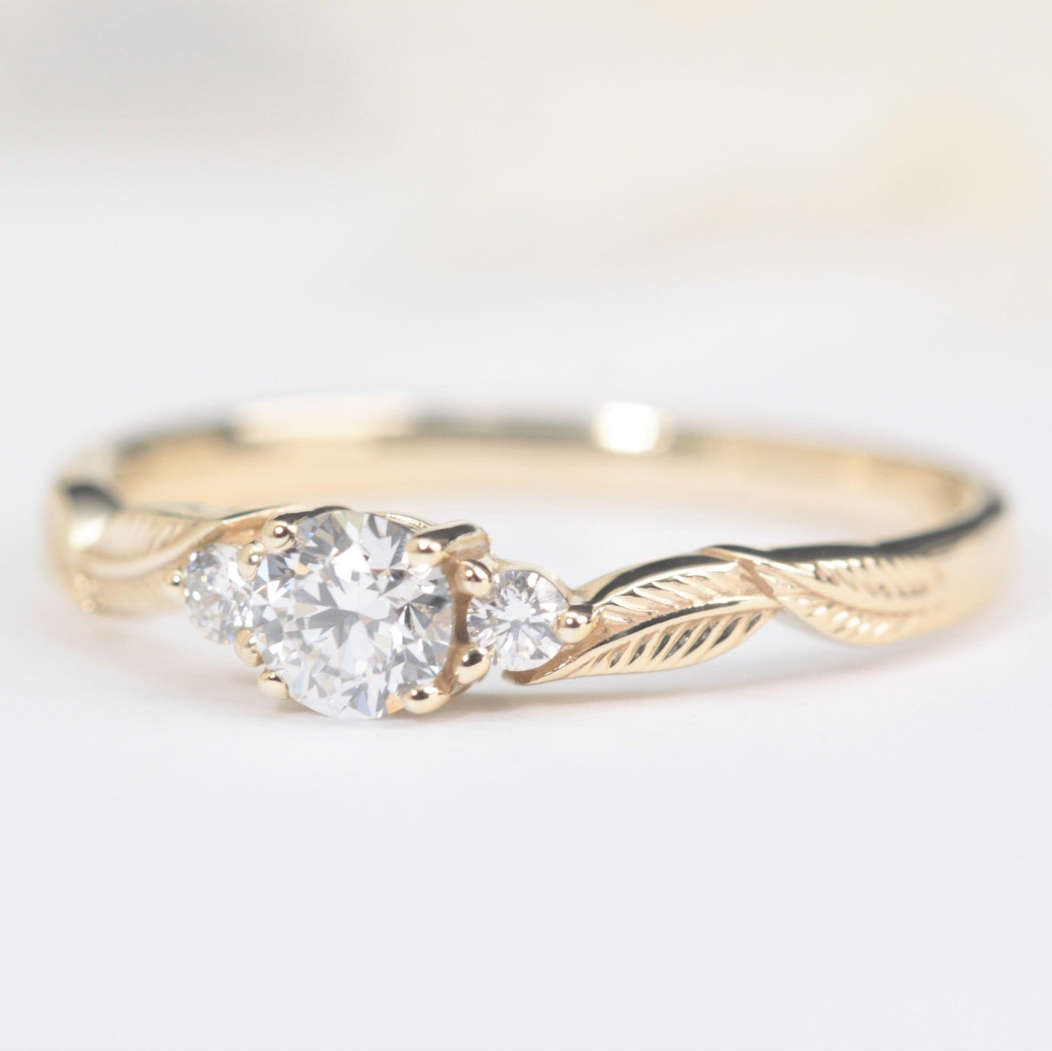 three diamond leaf engagement ring in yellow gold
